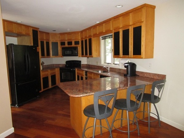 17 McKinley Road Marblehead, MA 01945 - Photo 5 of 22 a kitchen with stainless steel appliances granite countertop a dining table and chairs