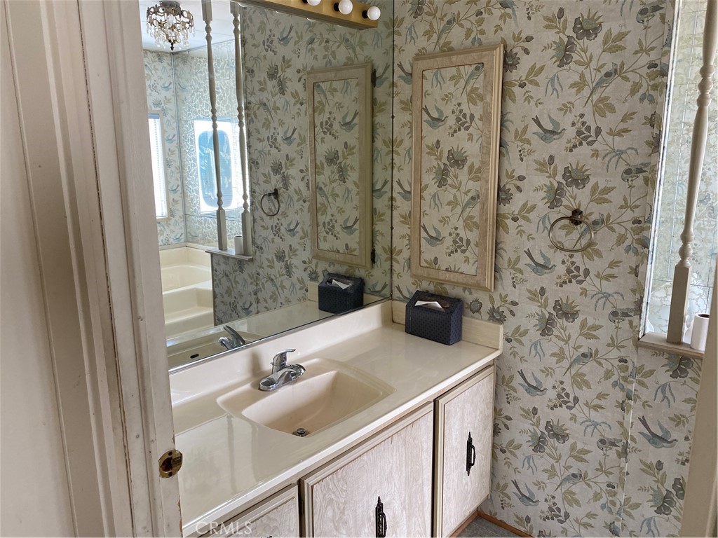 45 Walnut Via Anaheim, CA 92801 - Photo 11 of 14 a bathroom with a sink a vanity and a shower