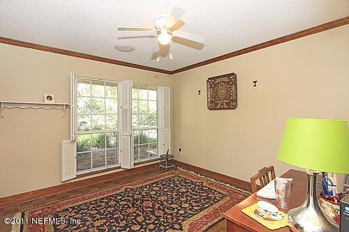 9628 Beauclerc Bluff Road Jacksonville, FL 32257 - Photo 12 of 31 a view of a bedroom with wooden floor and a ceiling fan