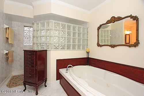9628 Beauclerc Bluff Road Jacksonville, FL 32257 - Photo 20 of 31 a bathroom with a bathtub and a shower