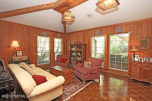 9628 Beauclerc Bluff Road Jacksonville, FL 32257 - Photo 3 of 31 a living room with furniture and a large window