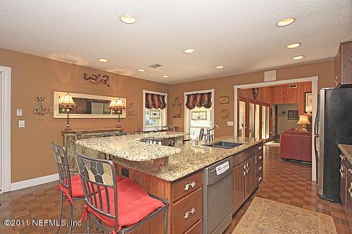 9628 Beauclerc Bluff Road Jacksonville, FL 32257 - Photo 6 of 31 a kitchen with stainless steel appliances granite countertop a refrigerator and stove