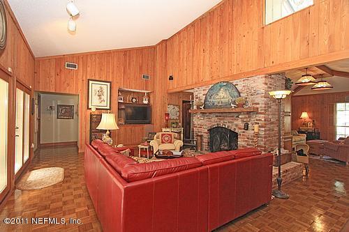 9628 Beauclerc Bluff Road Jacksonville, FL 32257 - Photo 8 of 31 a living room with fireplace furniture and a wooden floor