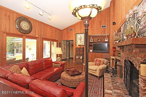 9628 Beauclerc Bluff Road Jacksonville, FL 32257 - Photo 9 of 31 a living room with furniture and a fireplace