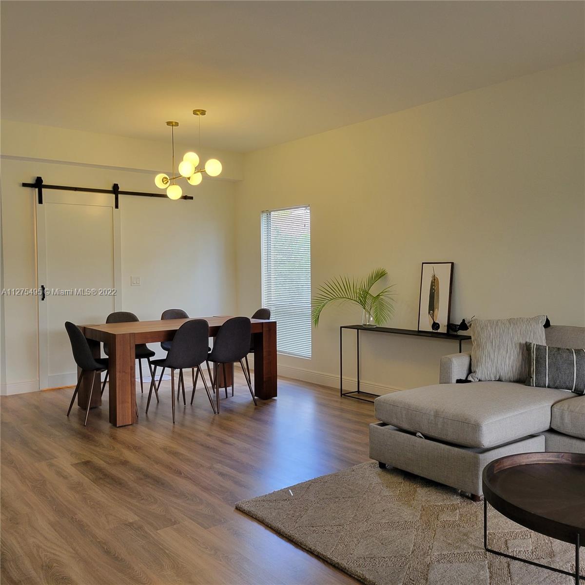 7896 Seville Place, Unit 1501 Boca Raton, FL 33433 - Photo 3 of 9 a living room with furniture and a wooden floor
