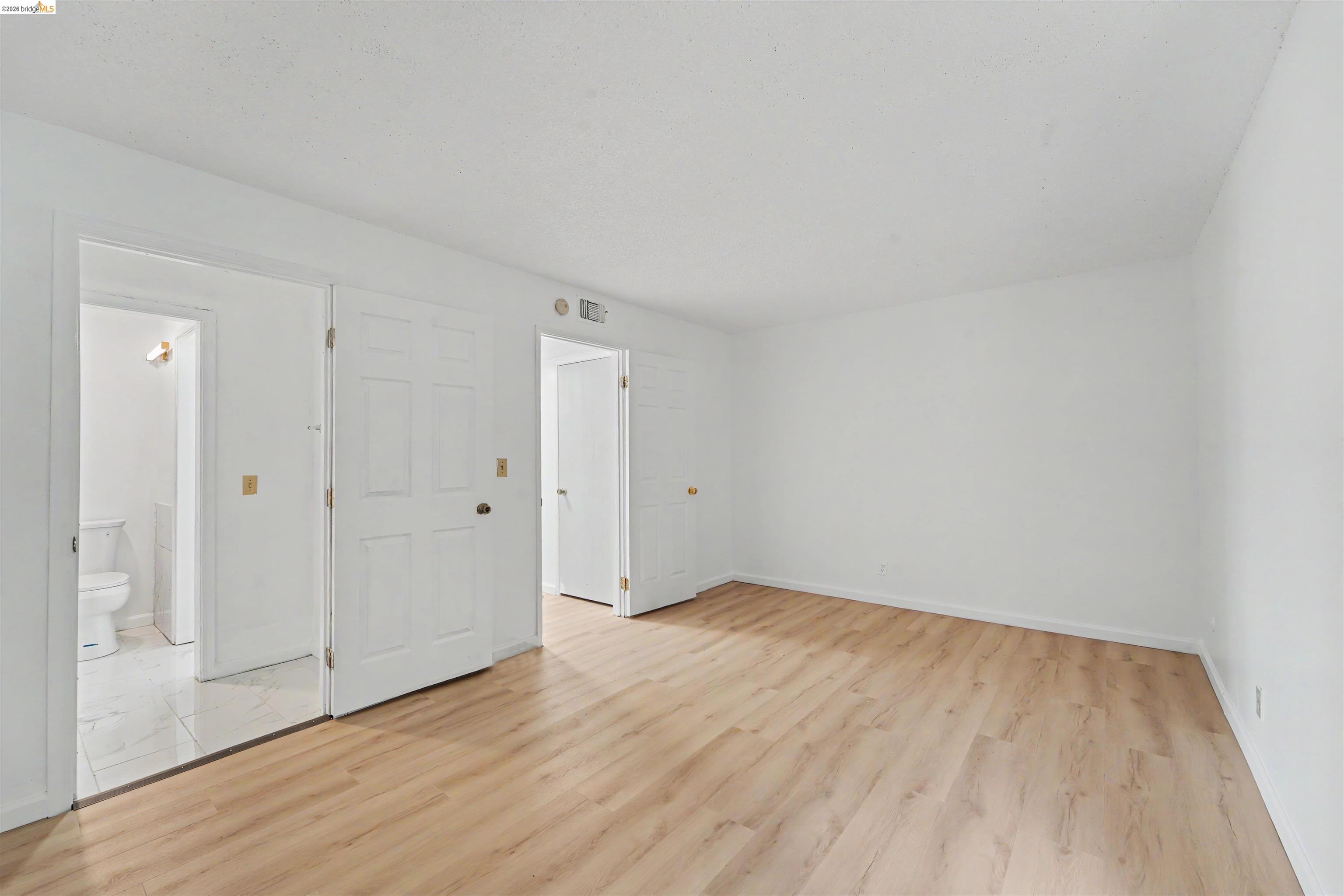 4186 San Pablo Dam Road, Unit A El Sobrante, CA 94803 - Photo 11 of 34 Bright room with light wood-finish flooring, white walls, and a white ceiling