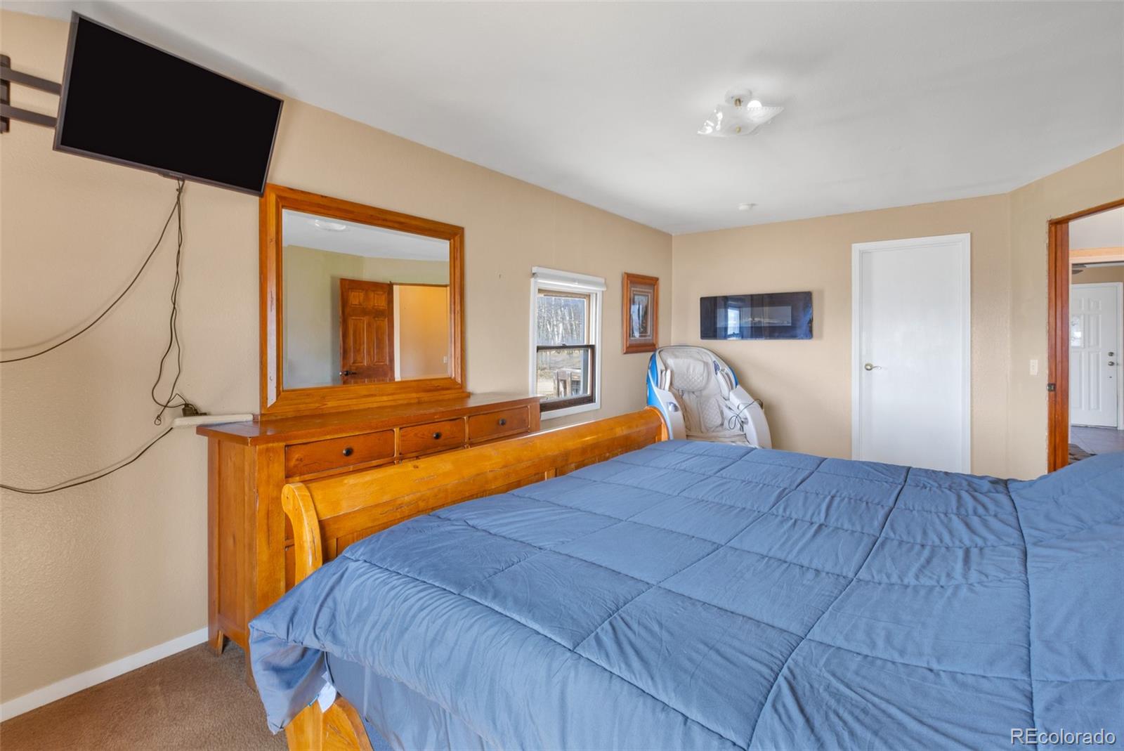 37 Warm Springs Road Fairplay, CO 80440 - Photo 20 of 50 a bedroom with a bed and a flat tv screen on dresser