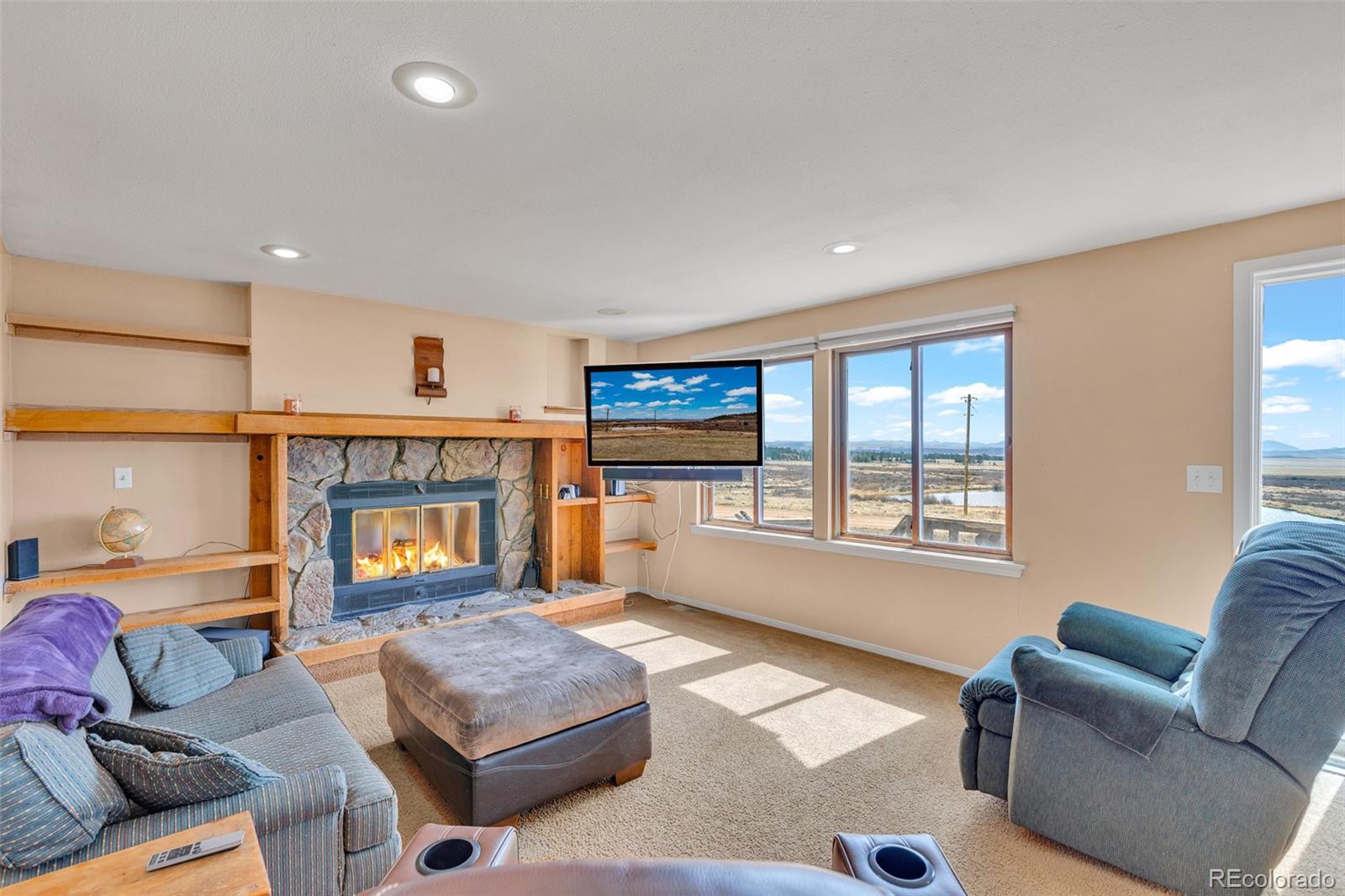 37 Warm Springs Road Fairplay, CO 80440 - Photo 27 of 50 a living room with furniture window and a fireplace