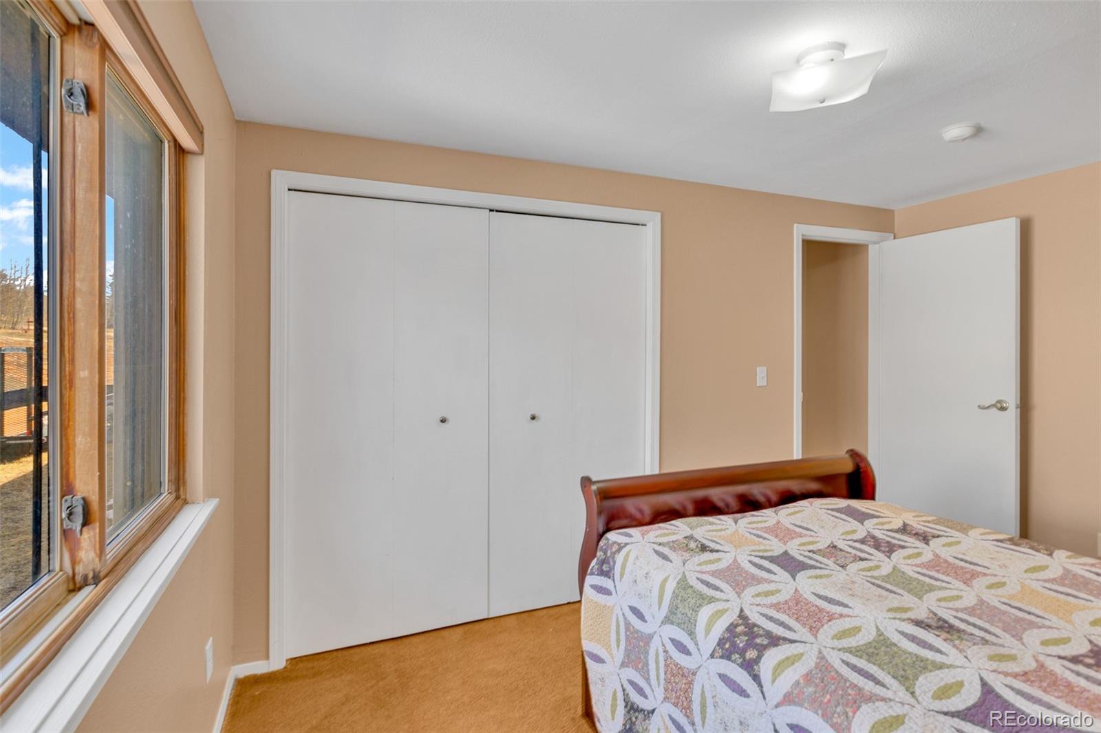 37 Warm Springs Road Fairplay, CO 80440 - Photo 33 of 50 a bedroom with a bed and a window