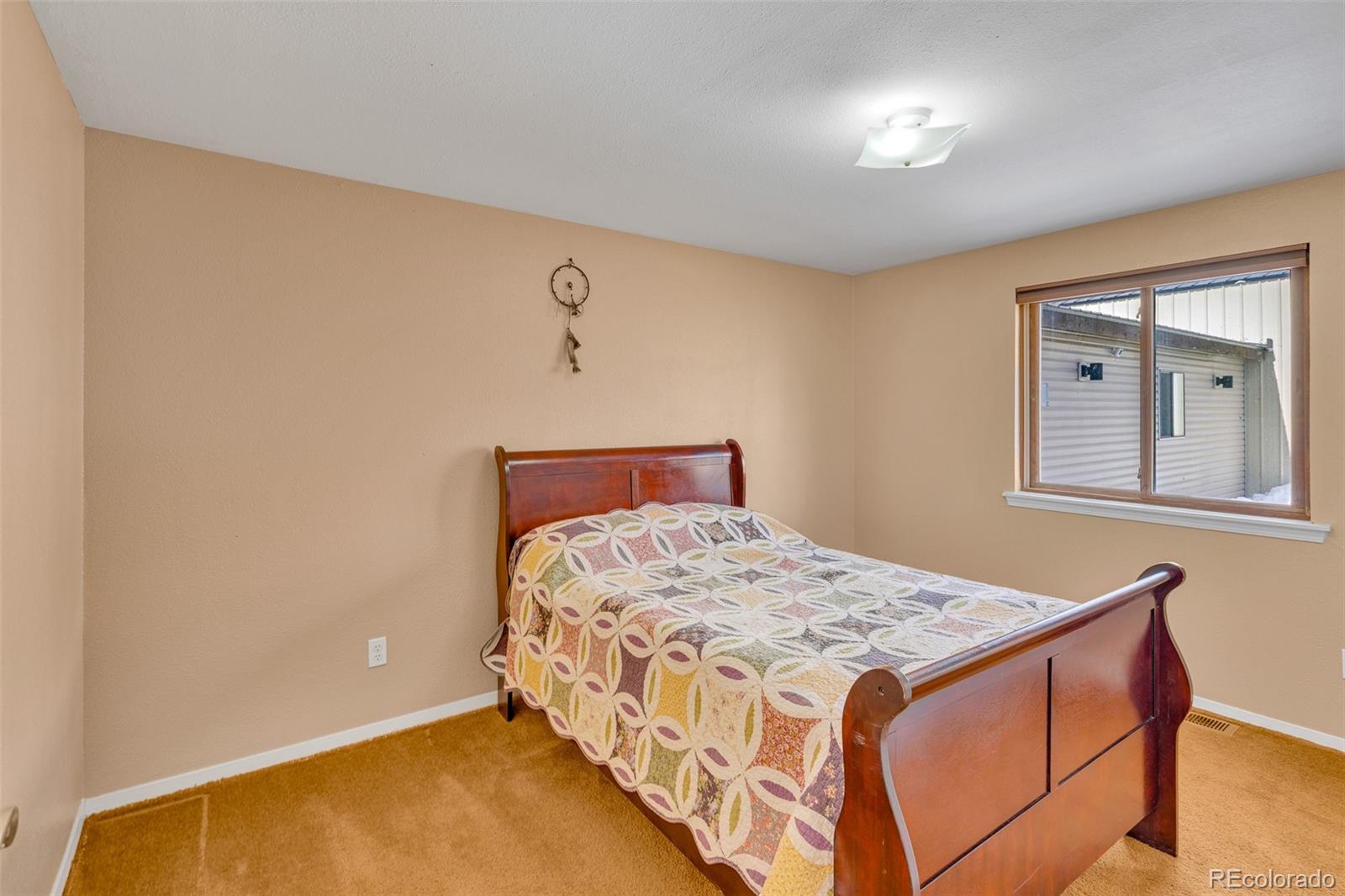 37 Warm Springs Road Fairplay, CO 80440 - Photo 34 of 50 a bed sitting in a bedroom next to a window