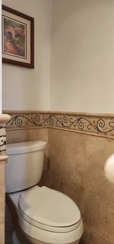 a white toilet sitting next to a bathroom sink