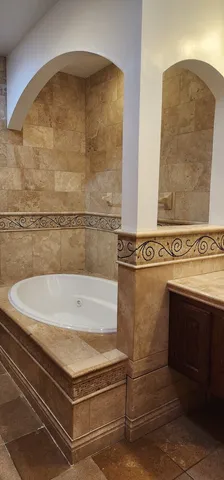 a bathroom with a tub and shower