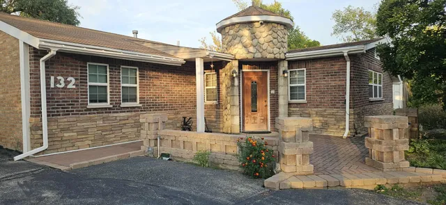 a front view of a house with garden