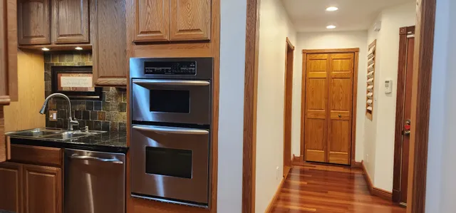 a kitchen with granite countertop a refrigerator and a sink