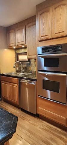 a kitchen with granite countertop a stove and a sink