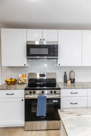 a kitchen with stainless steel appliances a stove a microwave and cabinets