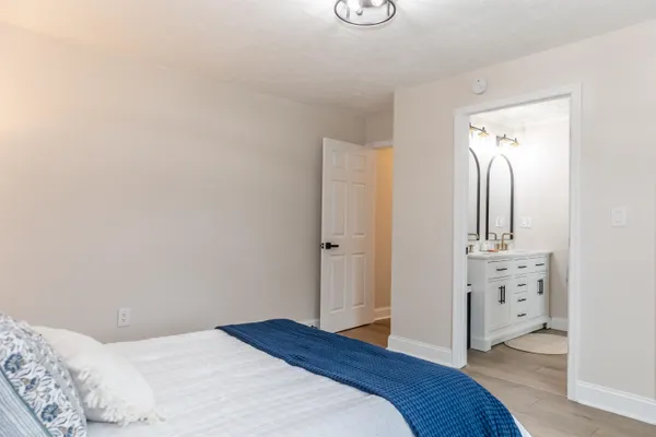 a bedroom with a bed and a dresser