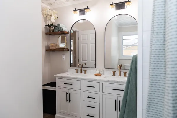 a bathroom with double vanity sink and mirror