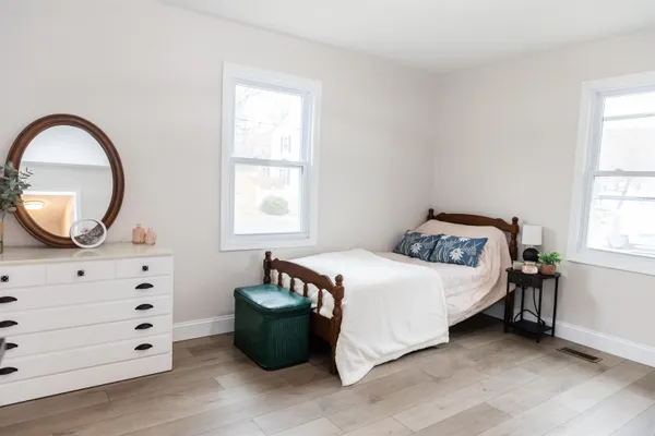 a bedroom with a bed and a mirror