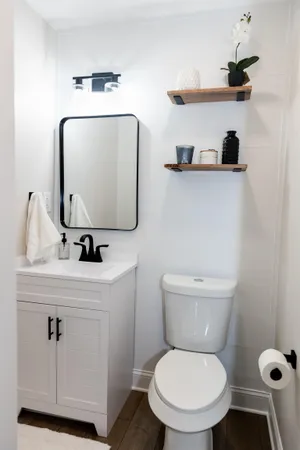 a bathroom with a toilet sink and mirror