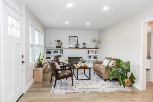 a living room with furniture and a potted plant