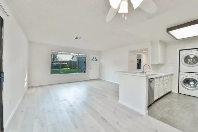 a view of a kitchen with a sink and a window