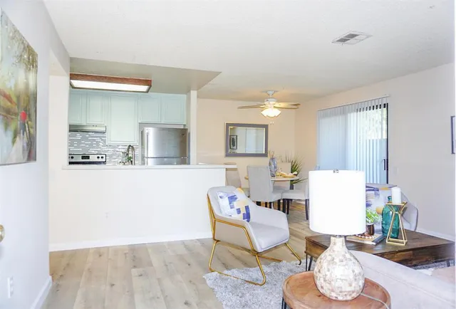 a living room with furniture and a wooden floor