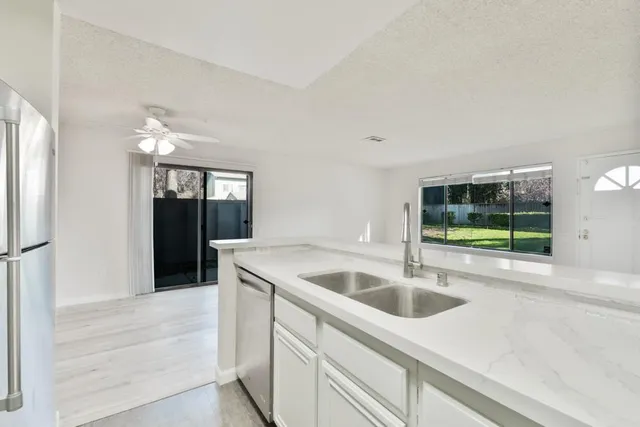 a kitchen with a sink cabinets and wooden floor