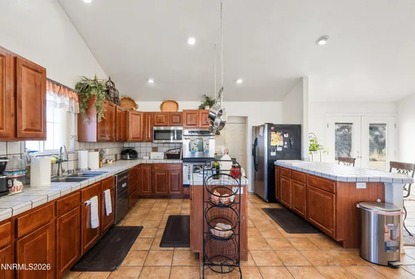 a large kitchen with lots of counter space and stainless steel appliances