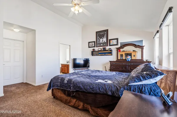 a bedroom with bed and window