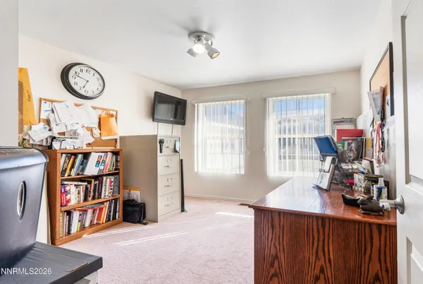 a view of a workspace with furniture and a bookshelf