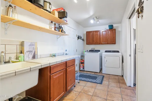 a utility room with cabinets washer and dryer