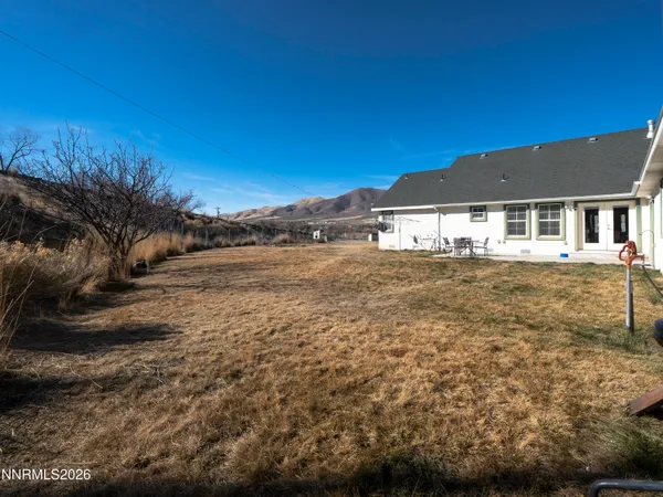a view of a yard with a house in the background
