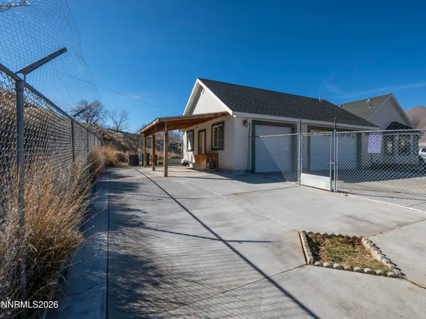 a view of a house with a wooden fence