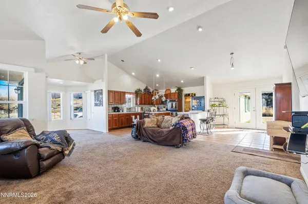 a living room with furniture and kitchen view