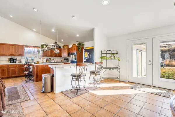 a living room with lots of furniture and kitchen view