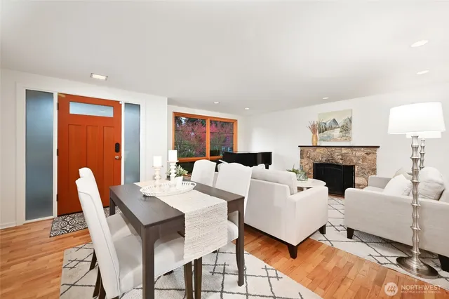 a living room with furniture a fireplace and a floor to ceiling window