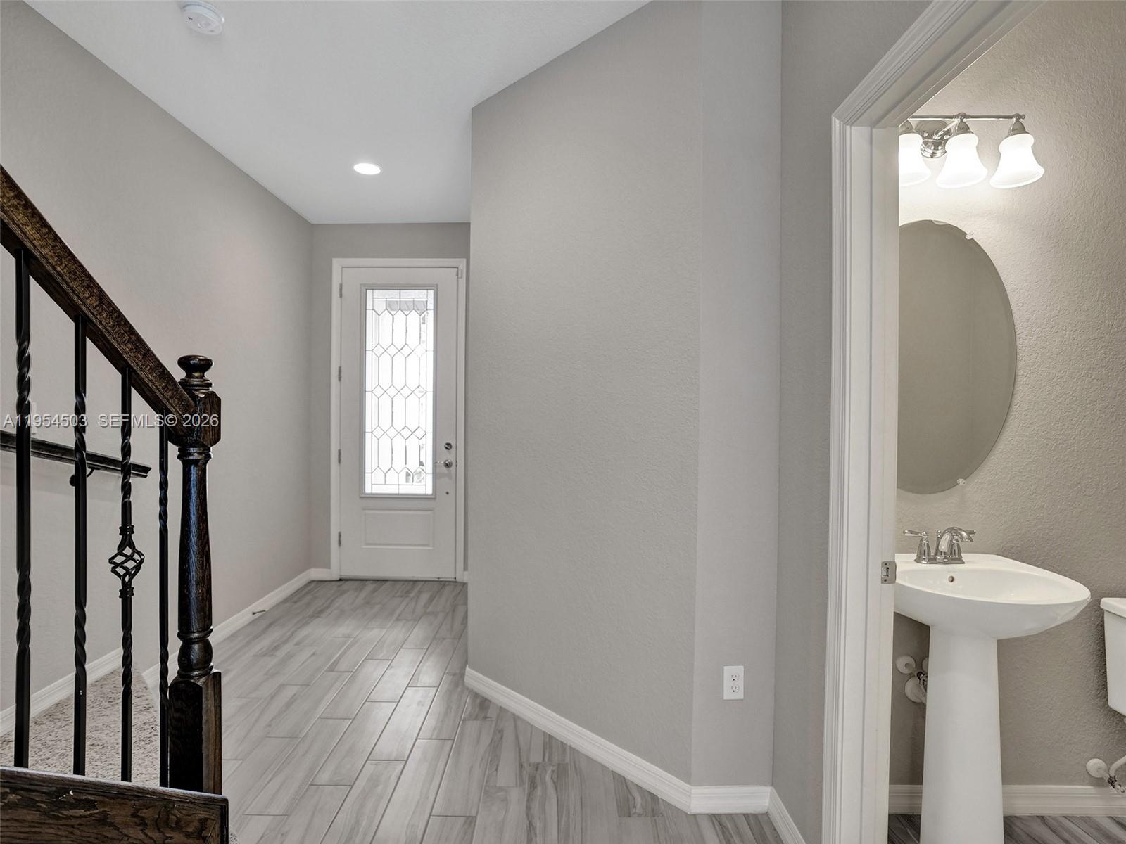 8330 Rearing Lane Lake Worth, FL 33467 - Photo 11 of 39 a view of a hallway with wooden floor and a mirror