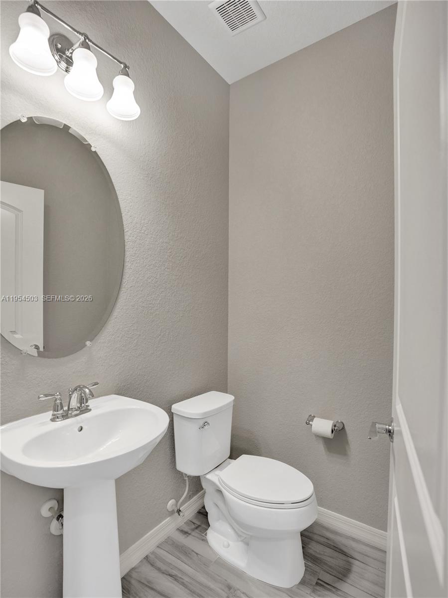 8330 Rearing Lane Lake Worth, FL 33467 - Photo 12 of 39 a bathroom with a sink toilet and a mirror