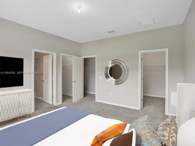 a bedroom with a bed and a television in it