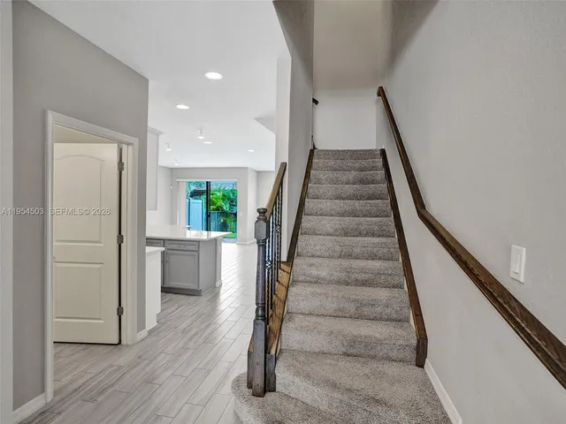 a view of entryway and hall with wooden floor