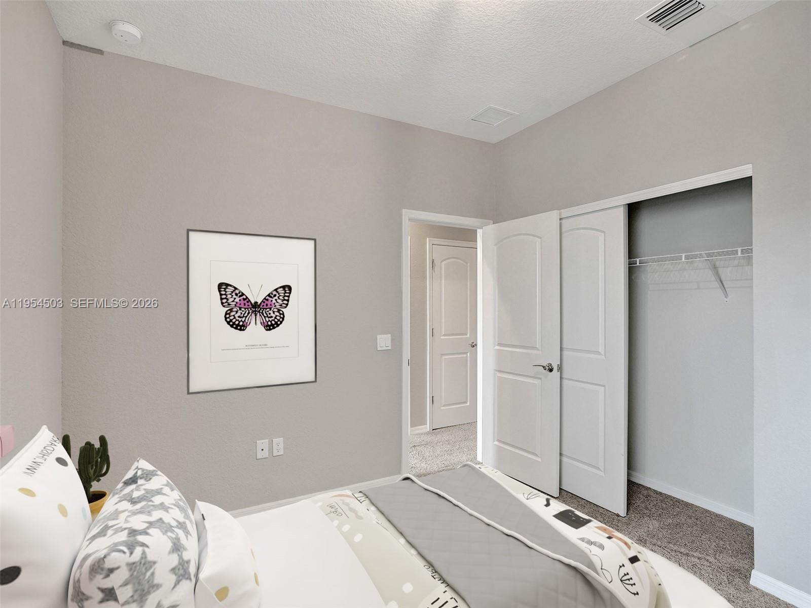 8330 Rearing Lane Lake Worth, FL 33467 - Photo 25 of 39 a bedroom with a bed and a painting on the wall