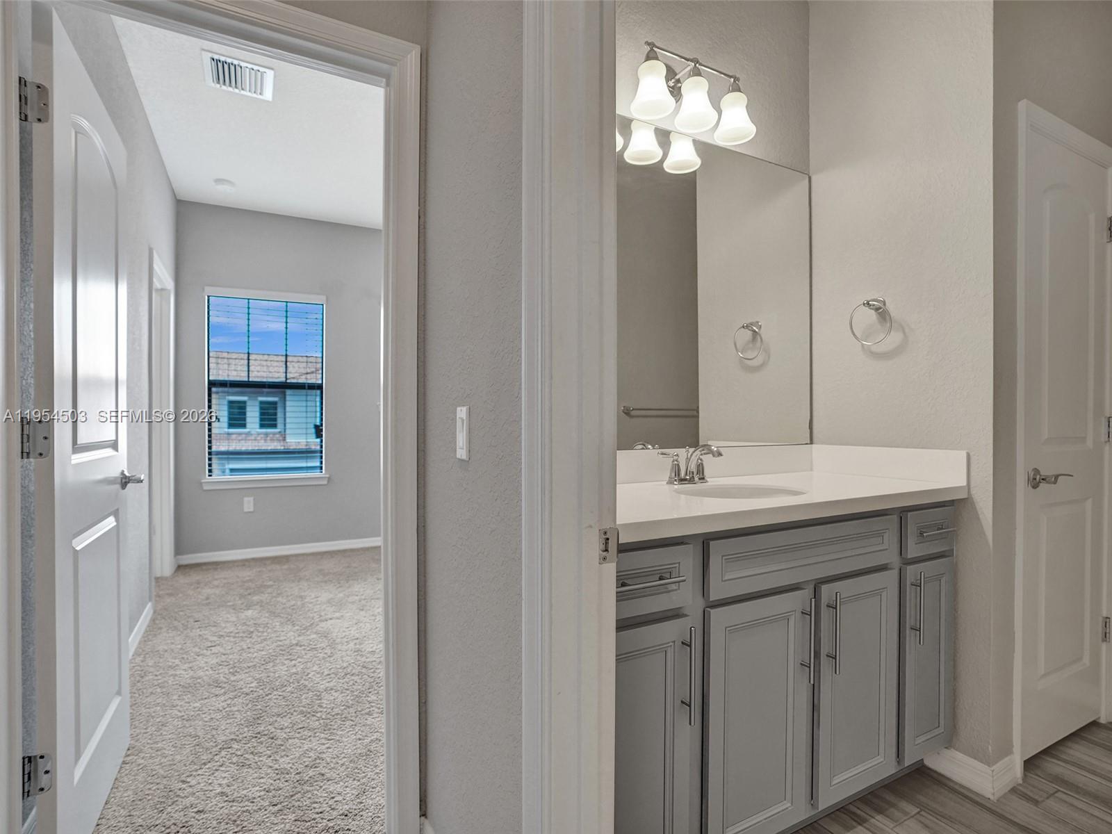 8330 Rearing Lane Lake Worth, FL 33467 - Photo 26 of 39 a bathroom with a double vanity sink and a mirror