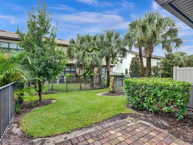 a front view of a house with a garden and yard