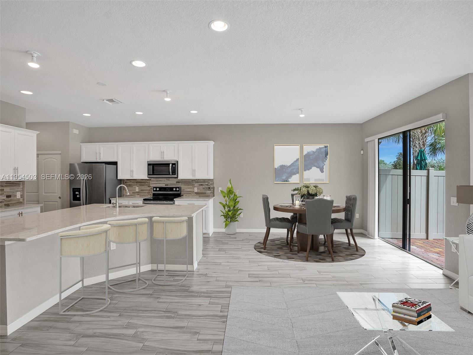 8330 Rearing Lane Lake Worth, FL 33467 - Photo 8 of 39 a kitchen with stainless steel appliances granite countertop a sink and cabinets