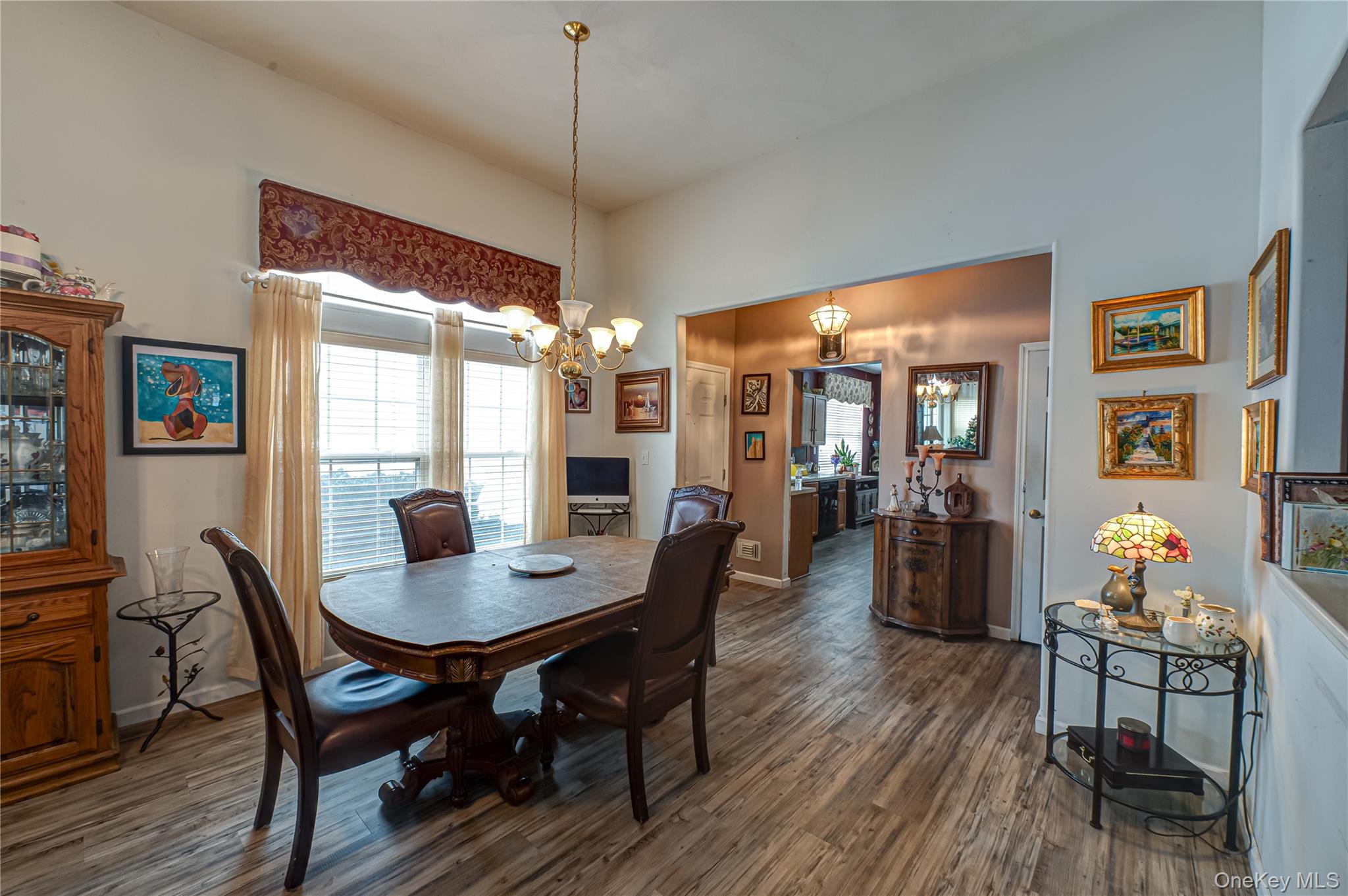 408 Leisure Drive Ridge, NY 11961 - Photo 3 of 17 a view of a dining room with furniture window and wooden floor