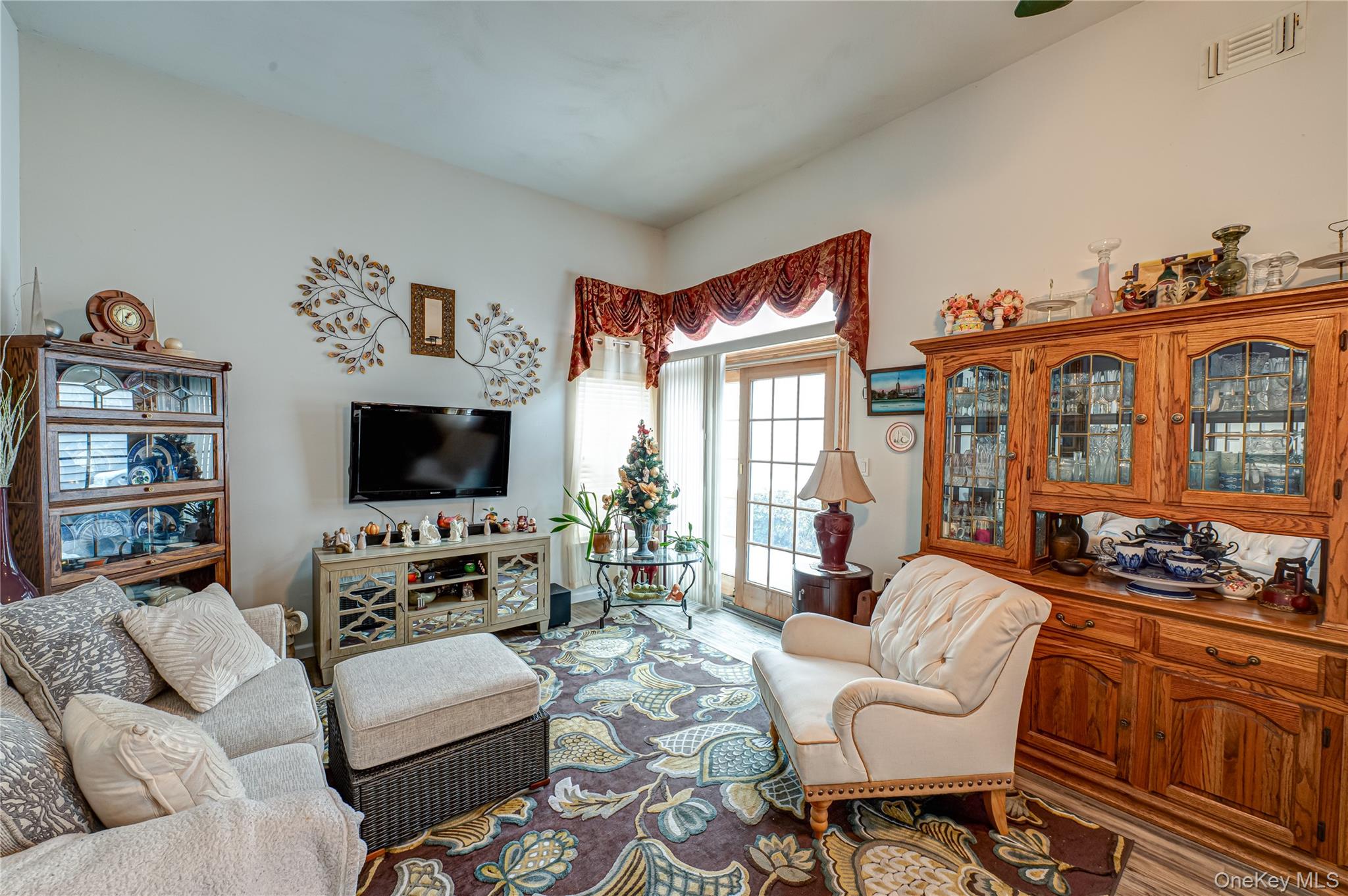 408 Leisure Drive Ridge, NY 11961 - Photo 5 of 17 a living room with furniture a flat screen tv and a fireplace