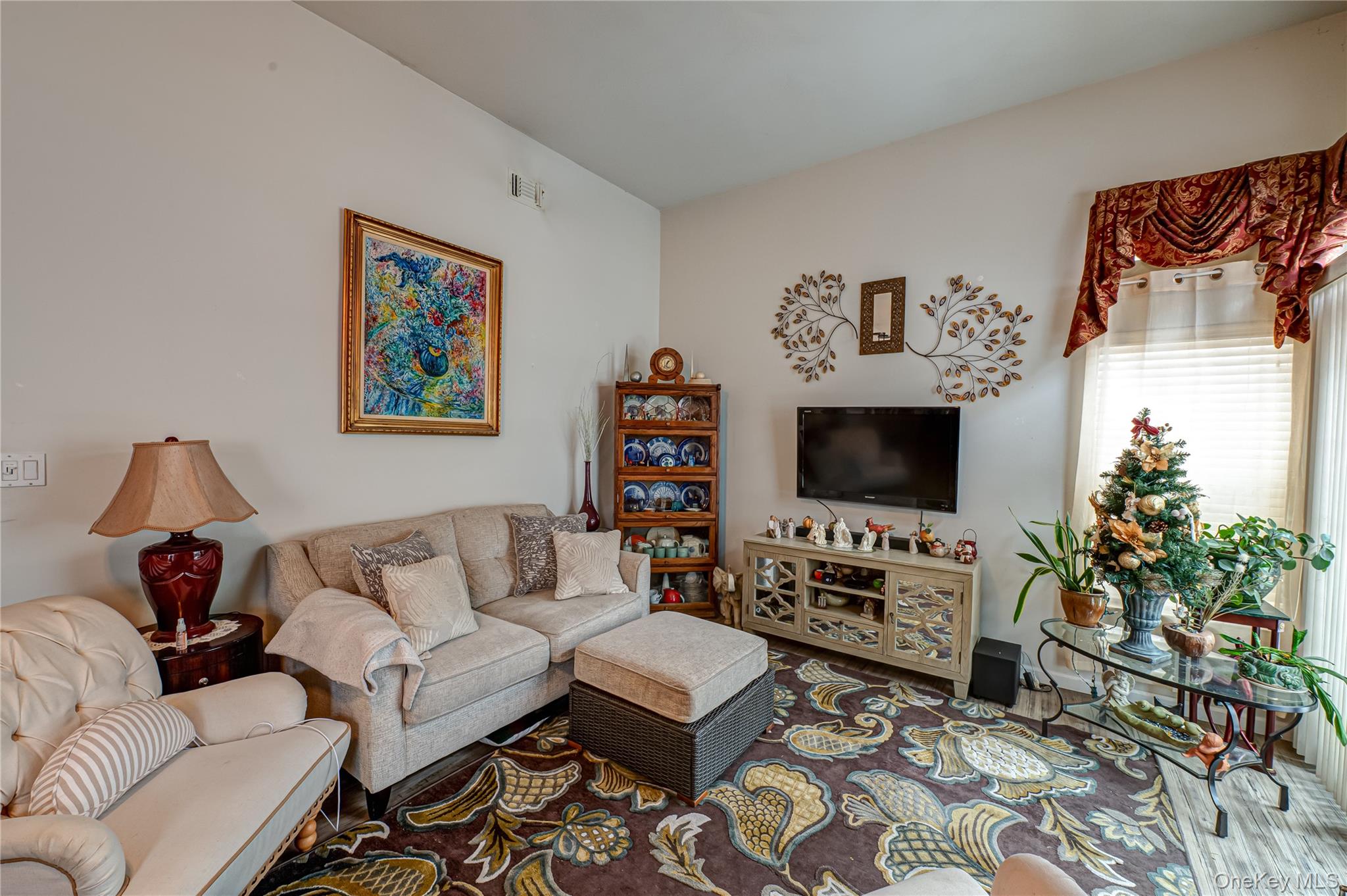 408 Leisure Drive Ridge, NY 11961 - Photo 6 of 17 a living room with furniture and a flat screen tv
