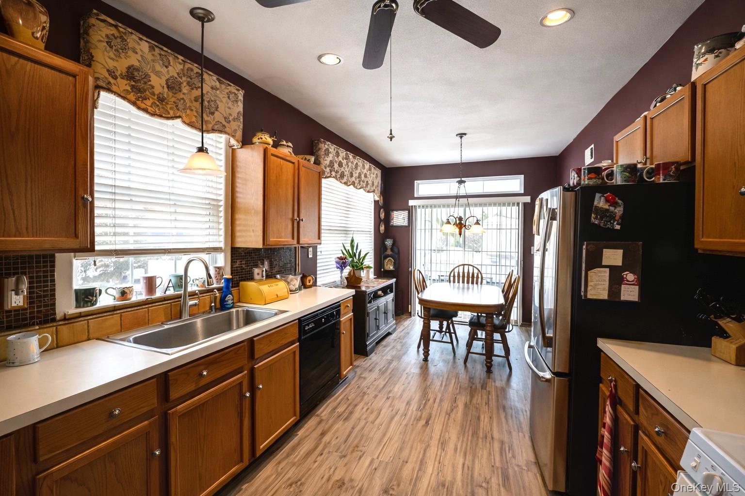 408 Leisure Drive Ridge, NY 11961 - Photo 7 of 17 a large kitchen with a large window and stainless steel appliances