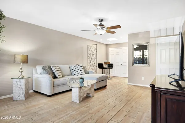 a living room with furniture and wooden floor